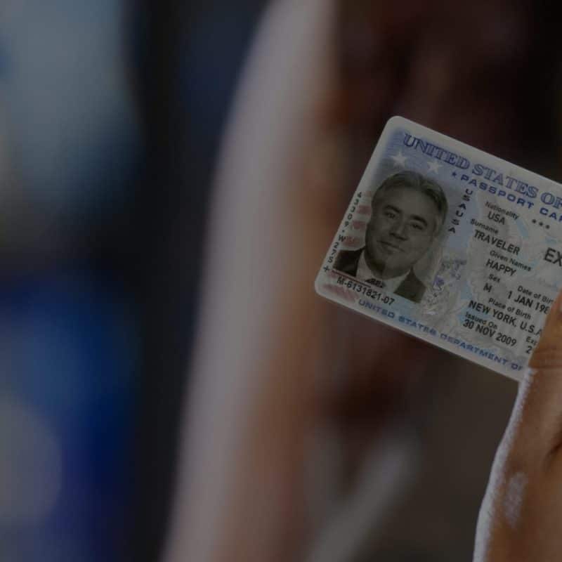 Person holding an identification card