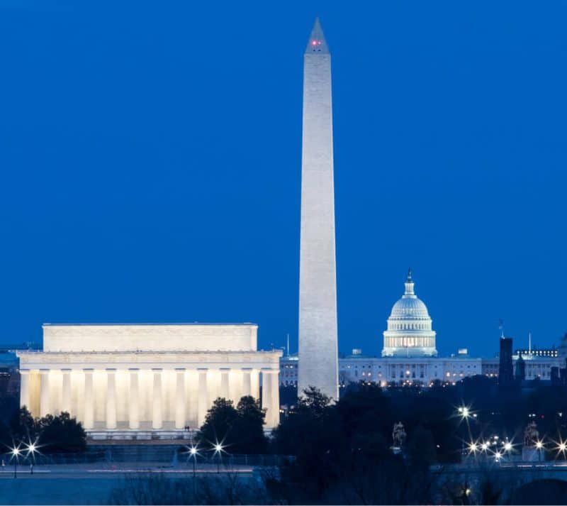 Washington monuments illuminated at dusk