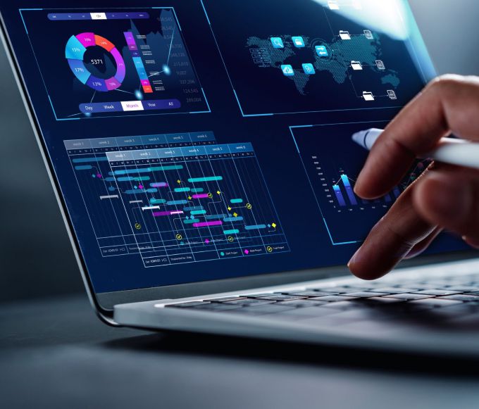 Person analyzing data on laptop